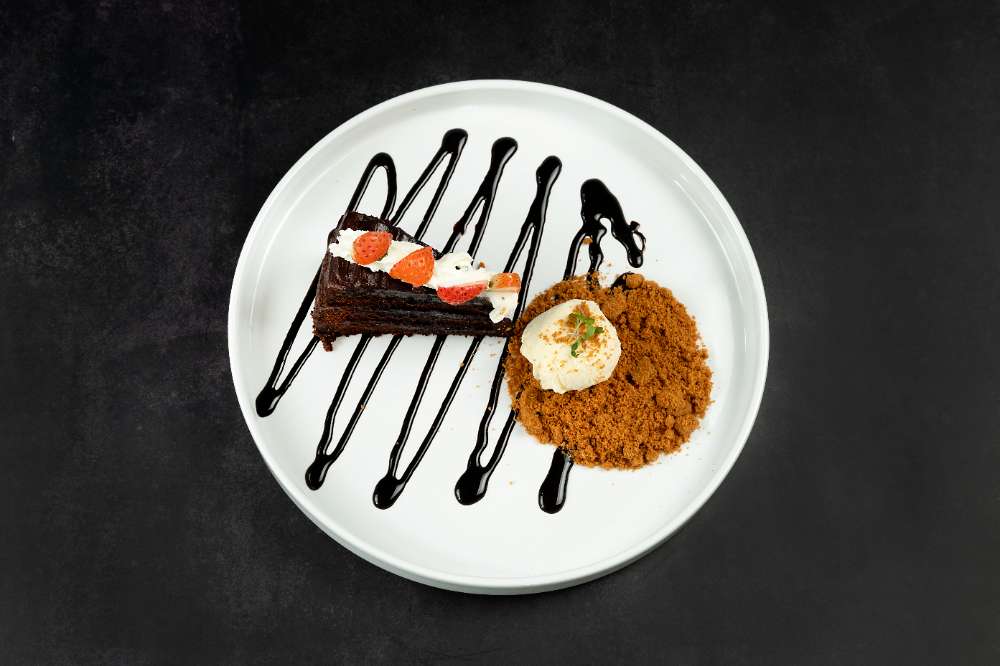Chocolate cake with strawberries, cream and a chocolate zig-zag