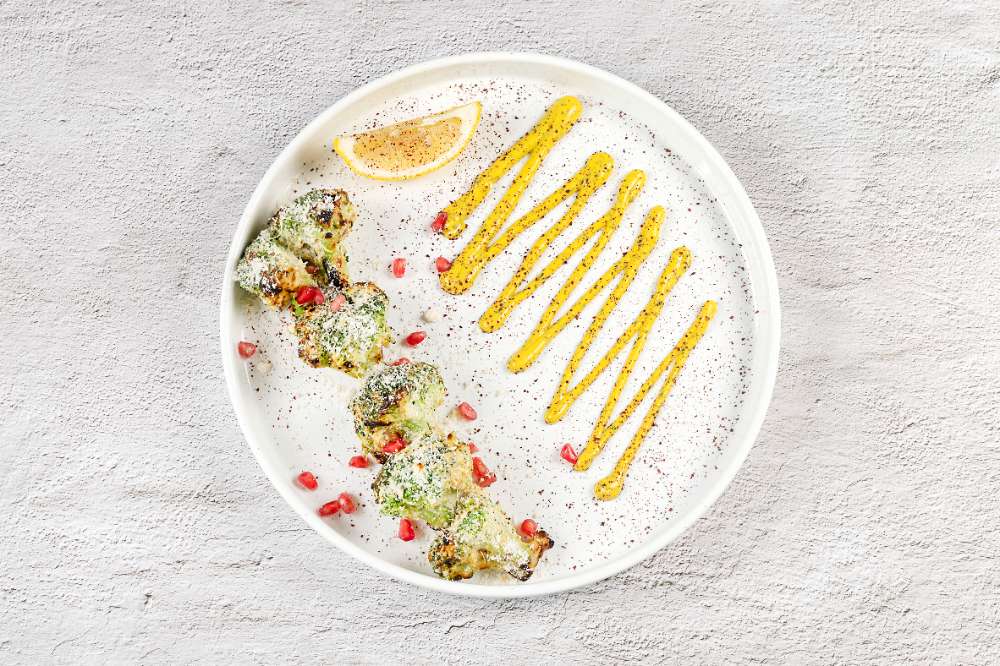 Chargrilled broccoli with pomegranate and a turmeric drizzle